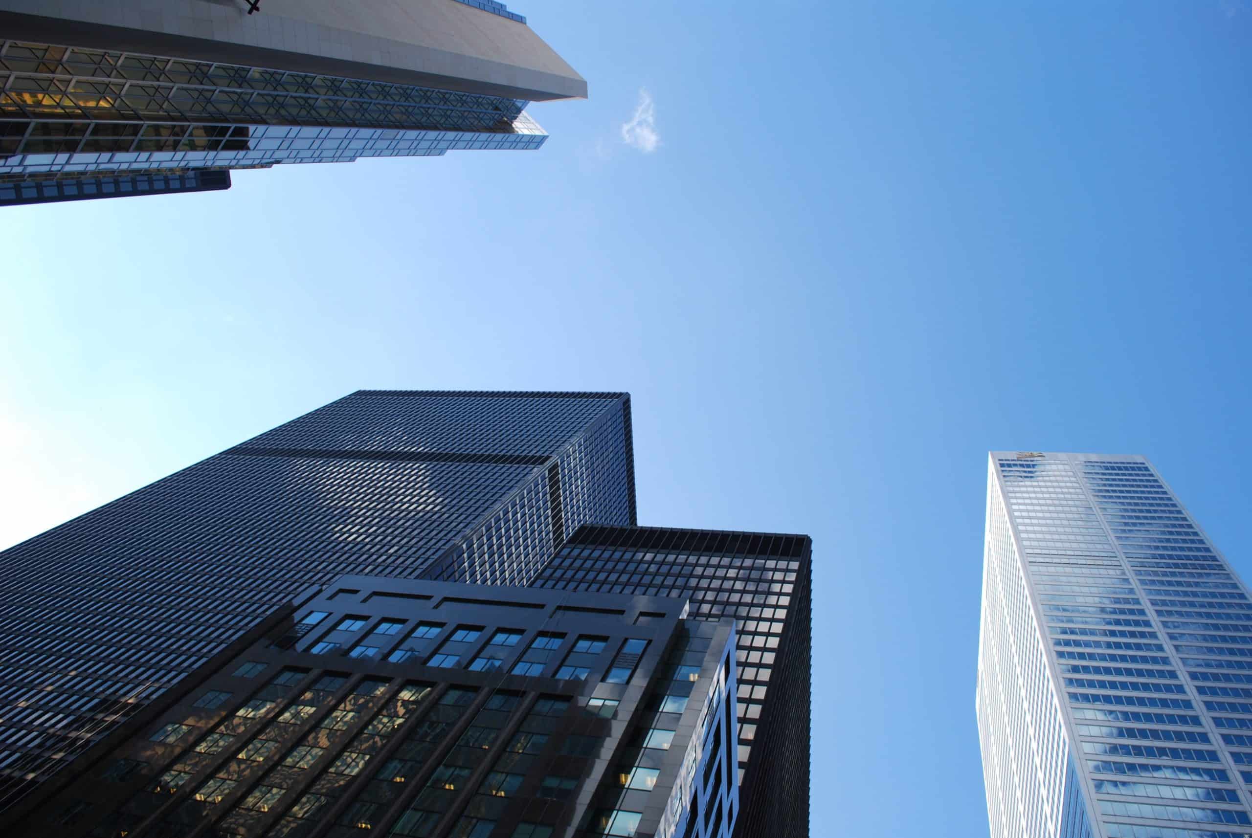 Skyscrapers in a city skyline with clear blue sky.