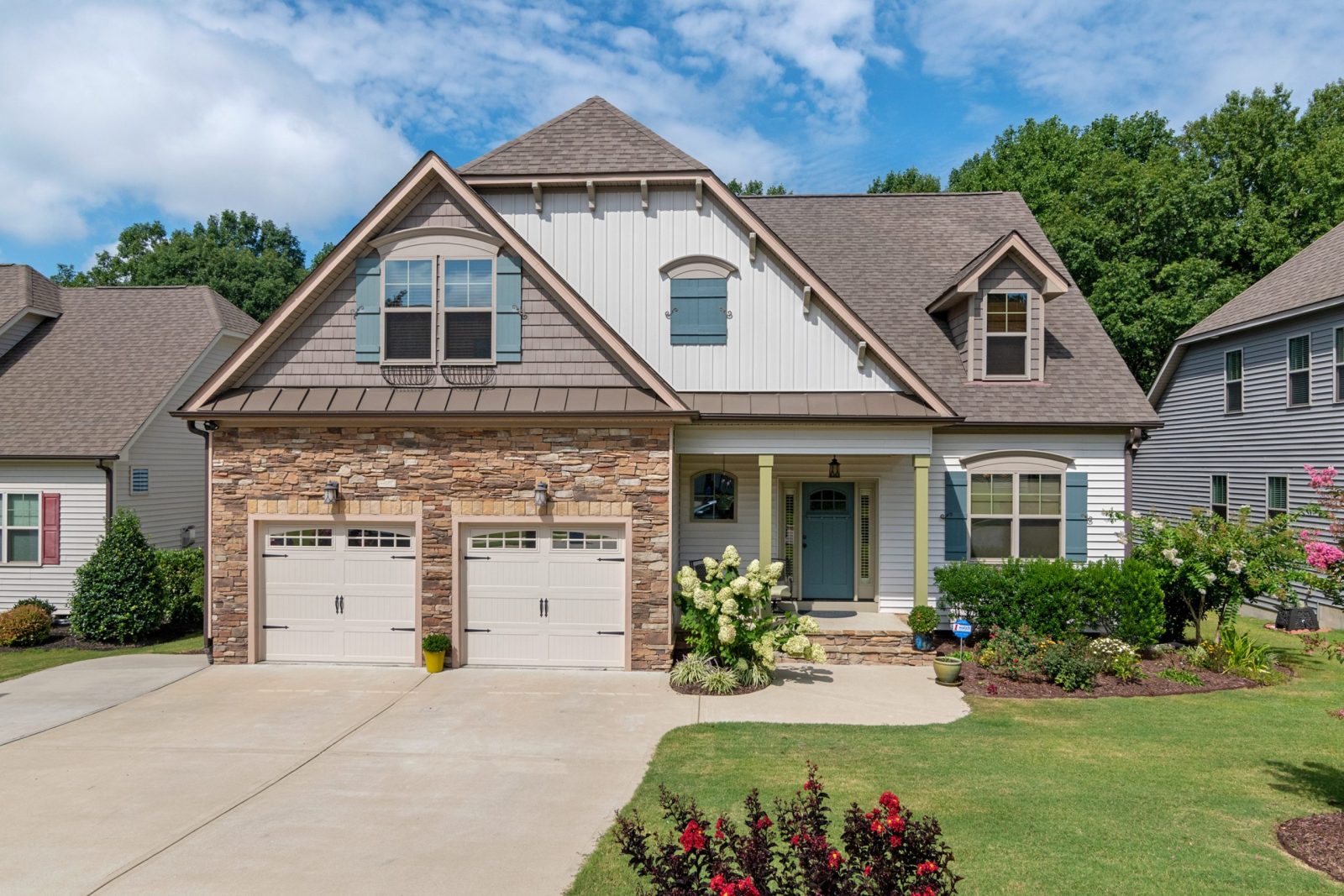 Contemporary house with octagon window and well-maintained garden.